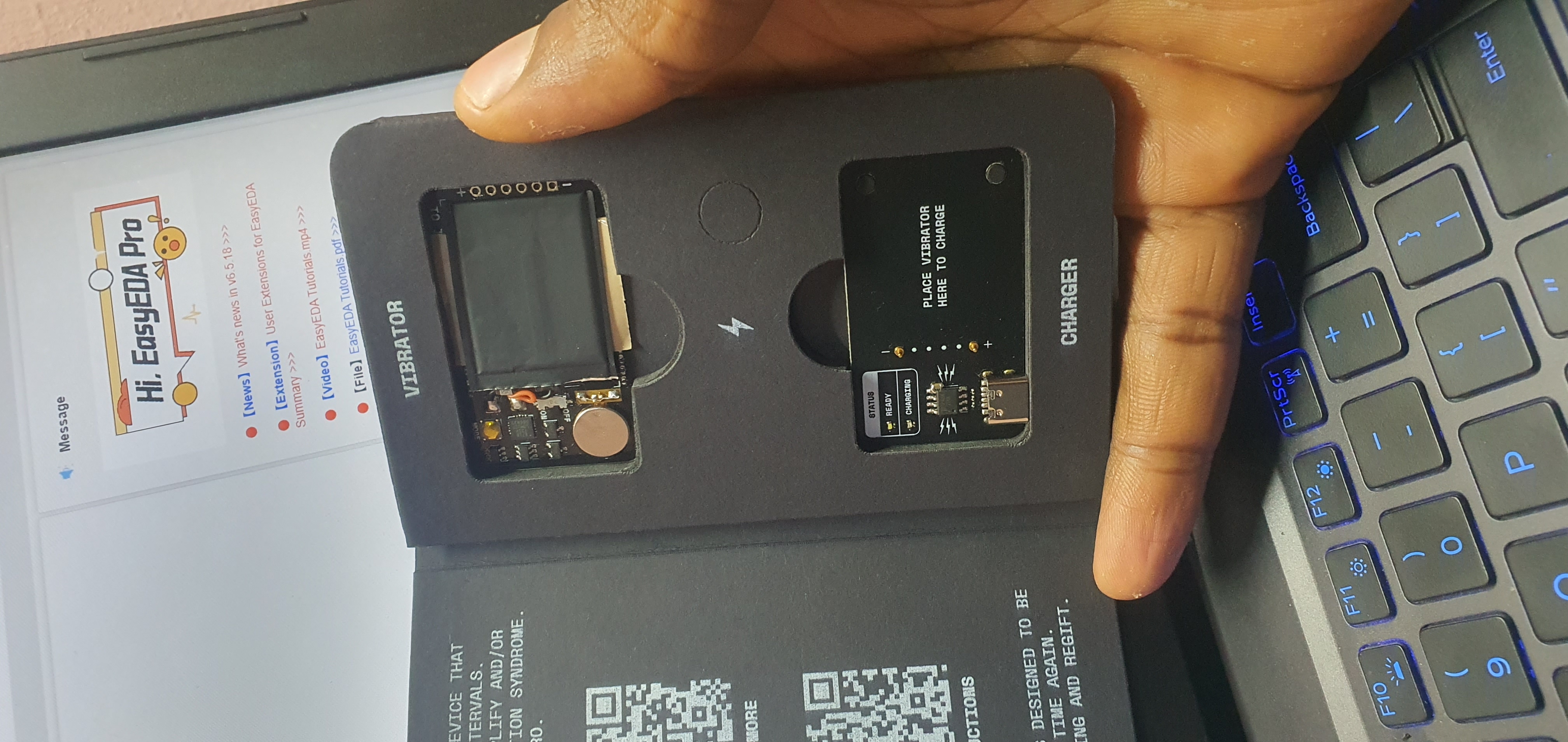 Buzz Nightmare packaging opened - vibrator board and charger board inside, 'Place Vibrator Here to Charge' label, QR code, instructions