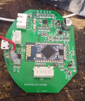 She Bops main PCB - circular green board with Bluetooth SoC, JST connectors, crystal oscillator, and SMD components